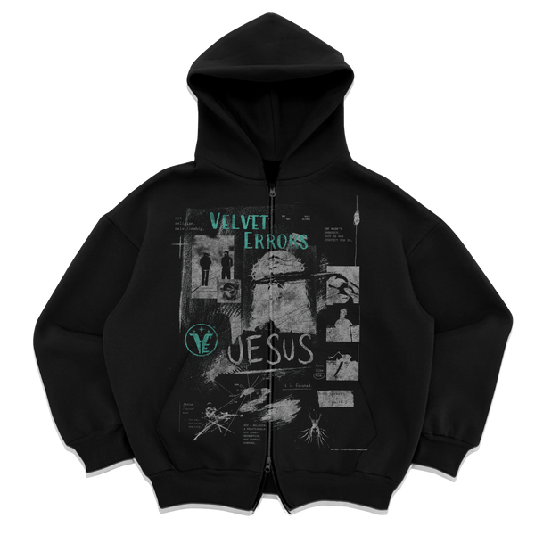Black zip-up hoodie by Velvet Errors, featuring a sleek design and soft fabric, shown on a hanger.